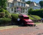 Woman Taken To Hospital After Truck Goes Over Wall